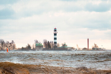 Fototapeta premium View to the Daugavgriva lighthouse from Mangalsala pier during stormy weather in Riga, Latvia