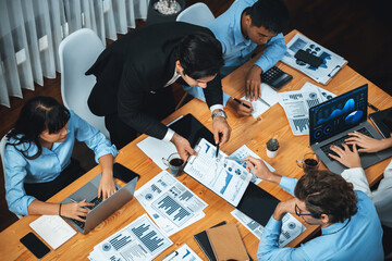 Wide top view of diverse group of business analyst team analyzing financial data report paper on meeting table. Chart and graph dashboard by business intelligence analysis. Meticulous - obrazy, fototapety, plakaty
