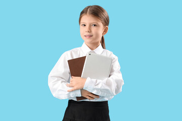 Cute little businesswoman with tablet computer and notebook on blue background. Opposite Day celebration