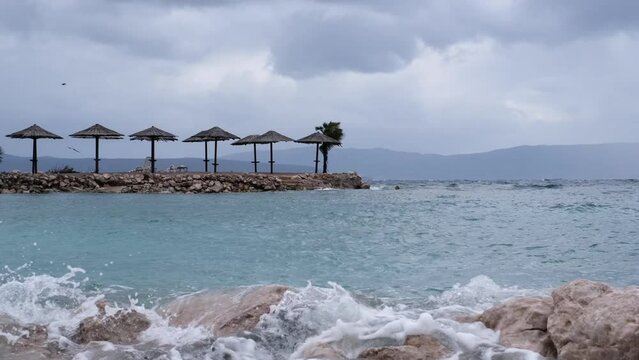 Beautiful cinematic water splashes. Powerful waves crashing the coast of Njivice, Croatia one day after Storm Ciar&aacute;n smashed into Krk Island. Birds flying above the disquiet sea surface.
