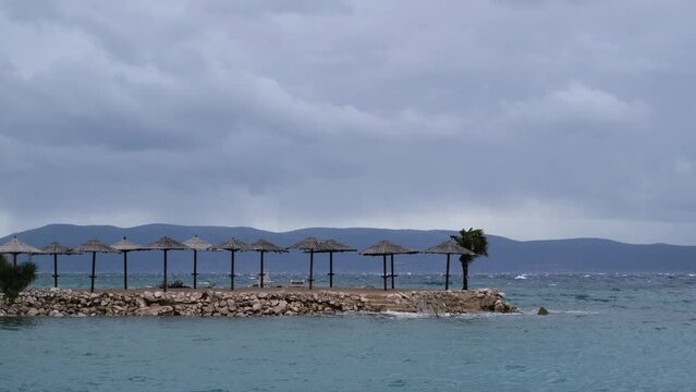 Powerful waves crashing the coast of Njivice, Croatia one day after Storm Ciar&aacute;n smashed into Krk Island. Beautiful rain curtain above the disquiet sea surface. Cinematic water splashes.