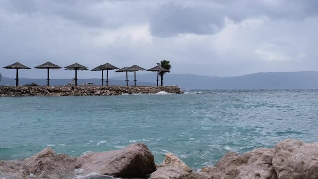 Powerful waves crashing the coast of Njivice, Croatia one day after Storm Ciar&aacute;n smashed into Krk Island. Beautiful rain curtain above the disquiet sea surface. Cinematic water splashes.