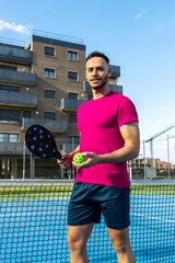 Vertical portrait of a happy young adult pickleball player posing looking at the camera.
