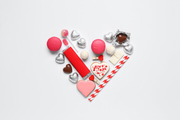 Heart made of different tasty sweets on white background. Valentine's Day celebration