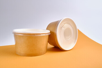 Kraft paper tableware: cups, food boxes, isolated on a light background. A set of various disposable tableware. Recycling and zero waste concept. Mock up
