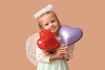 Cute little girl dressed as cupid with heart-shaped balloons on brown background. Valentine's Day...