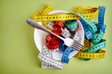 Empty plate with tape measure, knife and fork. The concept of diet, proper nutrition, health....