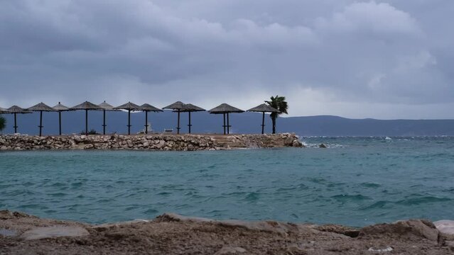 Powerful waves crashing the coast of Njivice, Croatia one day after Storm Ciar&aacute;n smashed into Krk Island. Beautiful rain curtain above the disquiet sea surface. Cinematic water splashes.