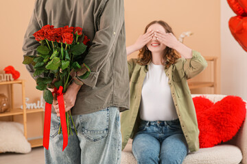 Man greeting his beloved girlfriend with Valentine's day at home