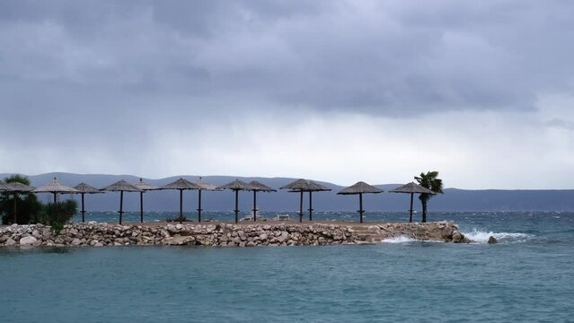 Powerful waves crashing the coast of Njivice, Croatia one day after Storm Ciar&aacute;n smashed into Krk Island. Beautiful rain curtain above the disquiet sea surface. Cinematic water splashes.