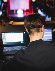 View of lighting technician operator working on mixing console workplace during live event concert...