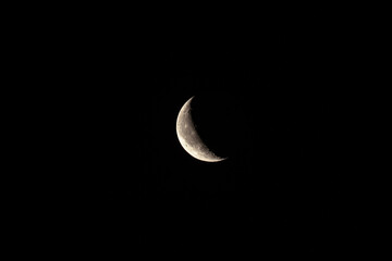 Obraz na płótnie Canvas Moon on black background. Waning moon in sky close-up. Earth satellite.