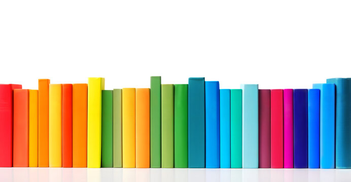 Row of books in colors of the rainbow isolated on white background