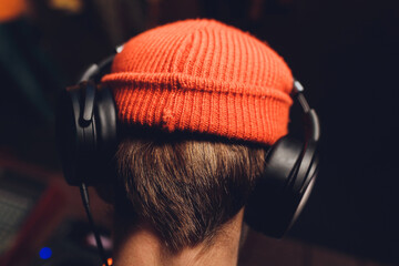 DJ playing music. Confident young DJ spinning on turntable while standing isolated.
