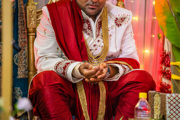 Indian Hindu wedding ceremony ritual items and hands close up