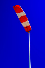 windsock in operation with strong blue sky background.
