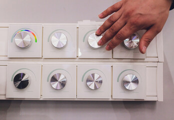 moderm switch control in hotel room Finger pressing light switch.