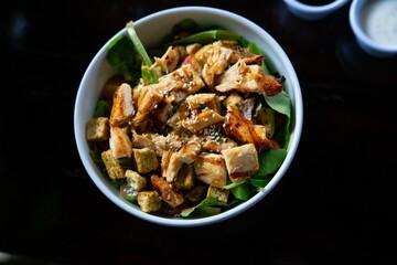 delicious and colorful chicken salad bowl at fast casual restaurant for lunch