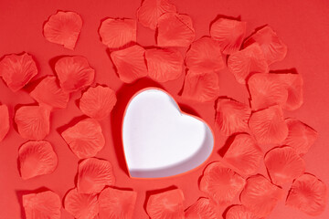 Saint Valentine heart shape on lay on petal on red background