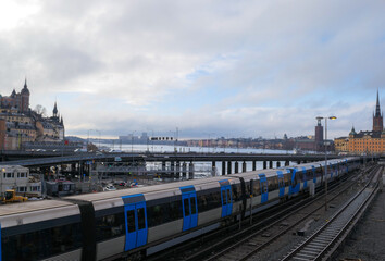 Fototapeta premium High angle view of a train crossing a bridge in the city