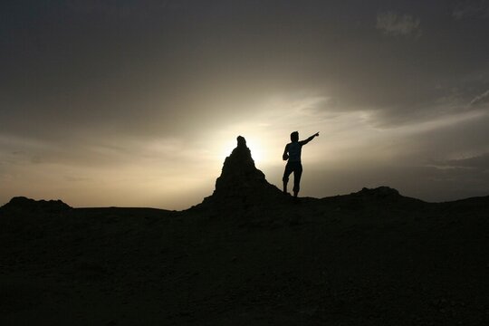 A tourist points to the sky near Ait Ben Haddou, Morocco, Africa
