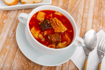 Traditional spanish dish Callos a la Madrilena served on a ceramic bowl in a restaurant