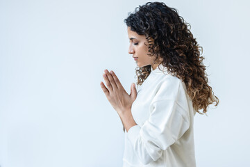 Zen peaceful woman dressed in a white tracksuit doing yoga poses in the studio
