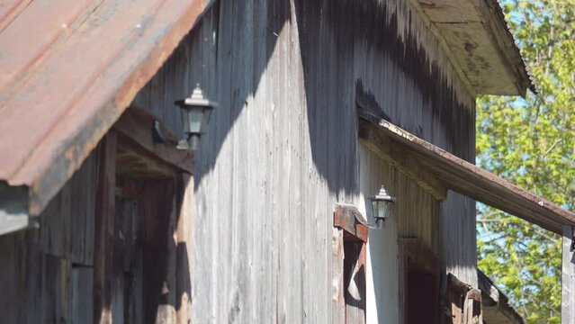Old wooden farm building with gray walls