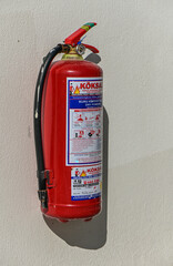 Fire extinguisher on a light wall in a residential complex 1