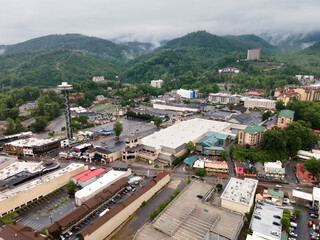 city of Gatlinburg in Tennessee and the Great Smoky Mountains from a bird's eye view, a tourist mecca with hotels, parking and shops.