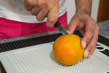 Man cutting an orange