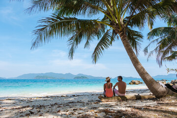 Koh Wai Island Thailand tropical Island near Koh Chang, couple of men and woman on the beach