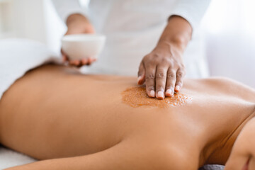 Obraz na płótnie Canvas Cropped of lady having skin scrubbing procedure at spa