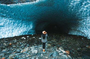 Girl standing and looking at “Big four ICE caves” on the cascades in Washington State, USA
