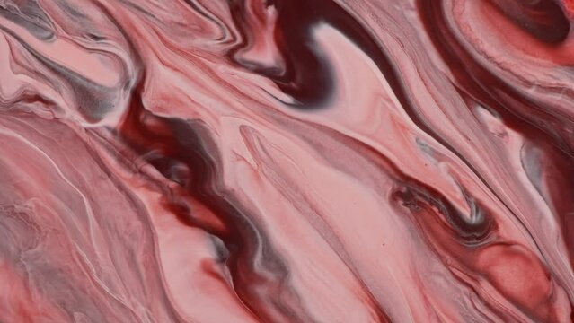 Sweeping waves of pink and brown merge in a marble fluid art pattern, creating an animated abstract background blending pastel colors.