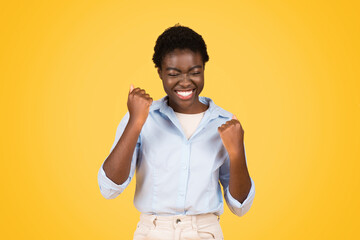 Fototapeta na wymiar Happy young african american woman student, exuding triumph and joy