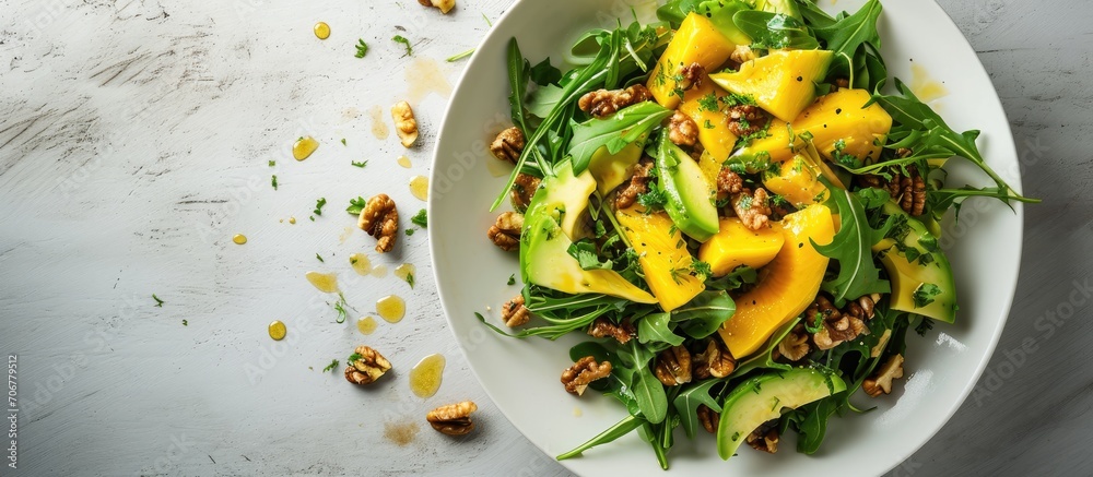 Leinwandbilder Salad with mango avocado arugula and walnuts. with copy space image. Place for adding text or design