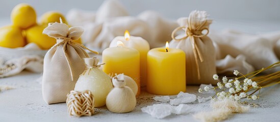 Obraz na płótnie Canvas Small gifts making handmade beeswax candles in organic cotton bags natural wedding favors bridal show ideas baptism baby shower gifts yellos white natural colors zero waste rustic style