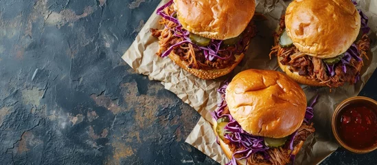 Foto op Plexiglas Pulled pork sandwiches with BBQ sauce cabbage and pickles overhead shot. with copy space image. Place for adding text or design © vxnaghiyev