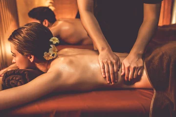 Foto auf Alu-Dibond Caucasian couple customer enjoying relaxing anti-stress spa massage and pampering with beauty skin recreation leisure in warm candle lighting ambient salon spa at luxury resort or hotel. Quiescent © Summit Art Creations