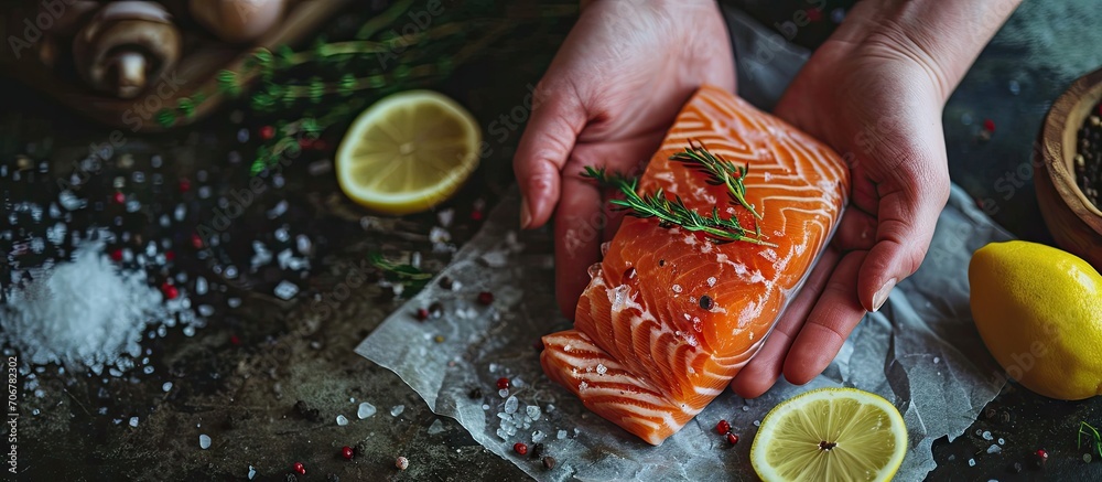 Leinwandbilder salmon is in the hands raw fish trout steak with spices and herbs place for text. with copy space im