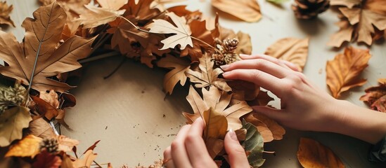 Step by step tutorial autumn paper wreath Step 4 use stapler to fix leaves in circle on cardboard form Top view. with copy space image. Place for adding text or design - obrazy, fototapety, plakaty
