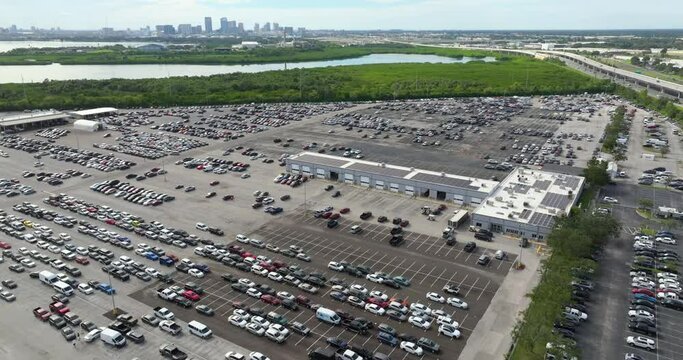 Used cars on dealer auction reseller company big parking lot ready for resale services. Sales of secondhand vehicles