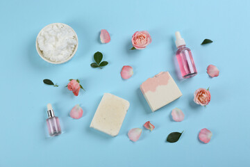 Flat lay composition with natural handmade soap and ingredients on light blue background