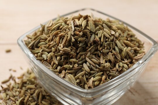 Fennel seeds in glass bowl on table, closeup