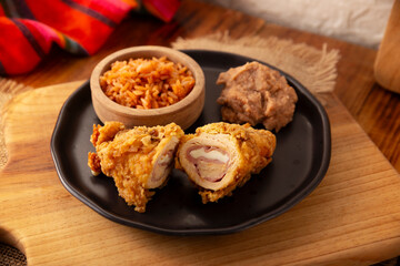 Chicken Cordon Bleu. Chicken breast meat wrapped with ham and cheese, breaded and fried or baked. Also known as schnitzel cordon bleu, a very popular recipe in many countries.