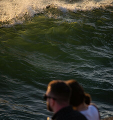 People watching the sunset by the ocean