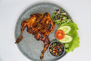 Bakakak Hayam or Ayam Bekakak or Grilled Whole Chicken with seasonings plus soy sauce, a dish from West Java and Jakarta, Indonesia. Usually served to brides at weddings.