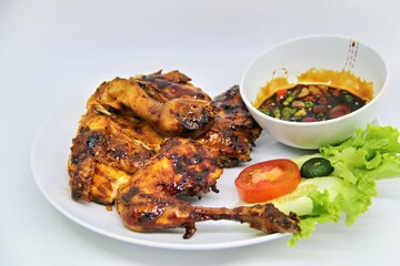 Bakakak Hayam or Ayam Bekakak or Grilled Whole Chicken with seasonings plus soy sauce, a dish from West Java and Jakarta, Indonesia. Usually served to brides at weddings.
