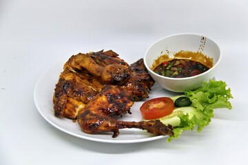 Bakakak Hayam or Ayam Bekakak or Grilled Whole Chicken with seasonings plus soy sauce, a dish from West Java and Jakarta, Indonesia. Usually served to brides at weddings.